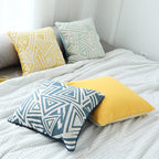 Square cushion cover with double-sided jacquard triangle motif and piping