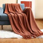 Dekorative Strick-Wohndecke mit Fransen