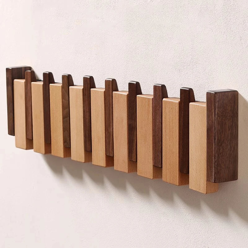 Garderobenleiste im Klavier-Design mit klappbaren Haken
