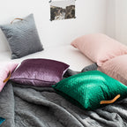 Square velvet cushion cover with geometric quilted pattern and leather handle