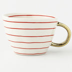 Tasse mit abstraktem geometrischem Muster und Goldhenkel