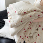 Quilt made of cotton satin with embroidered rose trim