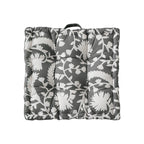 Padded floor cushion with quilted tufting, floral motif and carrying handle