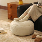 Low leather pouf with plush microfibre cover and shape-retaining foam filling