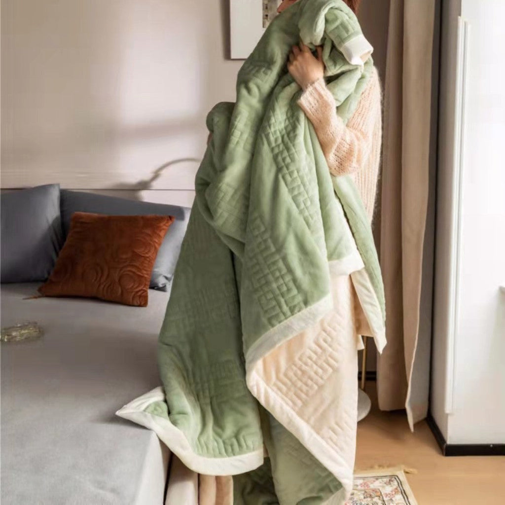 Reversible quilted comforter with structured box stitching and cotton trim