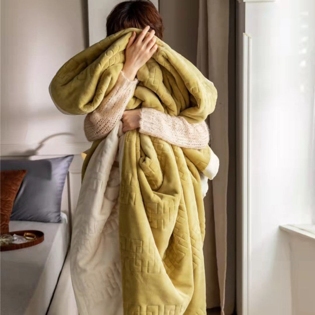 Reversible quilted comforter with structured box stitching and cotton trim